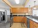 Updated kitchen features wood cabinets, granite countertops, stainless steel appliances and tile backsplash at 1706 S Ocean Blvd. # 1001, North Myrtle Beach, SC 29582