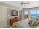 Spacious main bedroom offers beautiful ocean views from a private balcony, a ceiling fan and coastal decor at 1706 S Ocean Blvd. # 1001, North Myrtle Beach, SC 29582