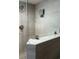 Contemporary bathroom shower with a glass partition, tiled walls, rainfall showerhead and mounted television at 1706 S Ocean Blvd. # 1001, North Myrtle Beach, SC 29582