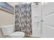 Clean bathroom showcasing a shower with a patterned curtain and a toilet at 2005 Silver Island Way, Murrells Inlet, SC 29576
