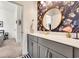 Stylish bathroom with round mirror, dual vanity, and floral accent wall at 2005 Silver Island Way, Murrells Inlet, SC 29576