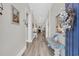 Bright hallway with wood floors, with a bench on the right, leading to the home's living areas at 2005 Silver Island Way, Murrells Inlet, SC 29576
