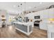 Modern kitchen with a center island, stainless steel appliances, and sleek white cabinetry at 2005 Silver Island Way, Murrells Inlet, SC 29576