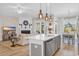 Open-concept kitchen with an island with bar seating overlooking the living room and fireplace at 2005 Silver Island Way, Murrells Inlet, SC 29576