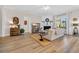 Bright living room with fireplace, plush sofa, light-colored wood flooring, and lots of natural light at 2005 Silver Island Way, Murrells Inlet, SC 29576