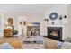 Cozy living room with a fireplace, wood floors, and a large television for entertainment at 2005 Silver Island Way, Murrells Inlet, SC 29576