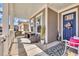 Inviting covered porch with stylish furnishings, including a wicker bench and a comfortable seating area at 2005 Silver Island Way, Murrells Inlet, SC 29576