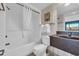 Standard bathroom featuring a shower/tub combo with white tiling and a dark brown vanity at 201 74Th Ave. N # 703, Myrtle Beach, SC 29572