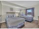 Bright bedroom featuring two beds with coastal-themed bedding, neutral walls, and a window view at 201 74Th Ave. N # 703, Myrtle Beach, SC 29572