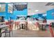 Bright dining area with light wood-look floors, red chairs, and several tables inside the building at 201 74Th Ave. N # 703, Myrtle Beach, SC 29572