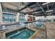 Relaxing indoor pool and jacuzzi area with lounge chairs and floor-to-ceiling beach views at 201 74Th Ave. N # 703, Myrtle Beach, SC 29572
