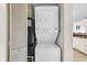 Convenient laundry closet with stacked washer and dryer, also including a wall-mounted AC unit at 201 74Th Ave. N # 703, Myrtle Beach, SC 29572