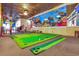 Fun indoor mini golf area featuring vibrant green turf, colorful decorations, and a whimsical ambiance at 201 74Th Ave. N # 703, Myrtle Beach, SC 29572