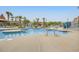 Large outdoor pool area surrounded by palm trees and sun loungers at 201 74Th Ave. N # 703, Myrtle Beach, SC 29572