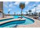 Beautiful outdoor lazy river pool area with palm trees, lounge chairs and blue skies at 201 74Th Ave. N # 703, Myrtle Beach, SC 29572