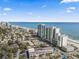 Coastal aerial view showcasing city condos, beaches, and the ocean under a bright sky, emphasizing the skyline at 201 S Ocean Blvd. # 217, Myrtle Beach, SC 29577