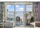 Balcony view with seating overlooking the beach and ocean through sliding glass doors in this bright vacation rental at 201 S Ocean Blvd. # 217, Myrtle Beach, SC 29577