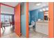Bathroom next to living area, offering bright blue walls, decorative nautical theme, and granite vanity at 201 S Ocean Blvd. # 217, Myrtle Beach, SC 29577