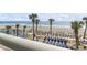 Beach view from a high vantage point, showing lounge chairs and palm trees on a sunny day at 201 S Ocean Blvd. # 217, Myrtle Beach, SC 29577
