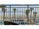 This beach view shows beach chairs, ocean, and palm trees at 201 S Ocean Blvd. # 217, Myrtle Beach, SC 29577
