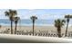 Beautiful beach view from above, including palm trees, beach chairs, and the ocean at 201 S Ocean Blvd. # 217, Myrtle Beach, SC 29577