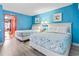 Bright bedroom with two beds, coastal decor, light-colored wood flooring, and an ocean view at 201 S Ocean Blvd. # 217, Myrtle Beach, SC 29577
