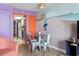 The dining area features a table with chairs, next to an orange door and a coastal themed mural at 201 S Ocean Blvd. # 217, Myrtle Beach, SC 29577