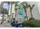 Sandy Beach Oceanfront sign with vacancy information surrounded by palm trees on a beautiful sunny day at 201 S Ocean Blvd. # 217, Myrtle Beach, SC 29577