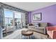 Comfortable living room includes sofa, sitting chairs, balcony with ocean views, and stylish decor at 201 S Ocean Blvd. # 217, Myrtle Beach, SC 29577