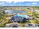 Aerial view of Heather Glen's clubhouse, pool and lake, surrounded by beautifully landscaped lawns and residential homes at 205 Kinross Ct., Little River, SC 29566