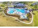 An aerial photograph showcases the Heather Glen community pool, hot tub, and clubhouse set among manicured lawns at 205 Kinross Ct., Little River, SC 29566