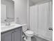 Clean bathroom featuring a white shower curtain, gray vanity, neutral colors, and tile floors at 205 Kinross Ct., Little River, SC 29566