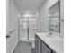 Bathroom with double sink vanity, white countertops, and a glass enclosed shower at 205 Kinross Ct., Little River, SC 29566