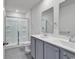 Modern bathroom featuring a double vanity, a glass-enclosed shower, neutral gray color, and tile floors at 205 Kinross Ct., Little River, SC 29566