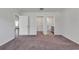 A well-lit bedroom boasts carpet floors with doorways to a walk-in closet and full bathroom at 205 Kinross Ct., Little River, SC 29566