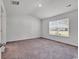 Bright bedroom featuring neutral walls, carpeted floor, and a window with natural light at 205 Kinross Ct., Little River, SC 29566