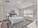 Bright bedroom with neutral decor, featuring carpeted floors, large windows, and a comfortable bed at 205 Kinross Ct., Little River, SC 29566