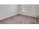 Bedroom features a window for natural light and neutral carpet at 205 Kinross Ct., Little River, SC 29566