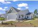Charming two-story home featuring an attached two-car garage and well-maintained lawn and landscaping at 205 Kinross Ct., Little River, SC 29566