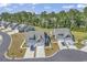 Two new construction homes sit side-by-side, featuring light-colored siding, inviting driveways, and well-manicured landscaping at 205 Kinross Ct., Little River, SC 29566