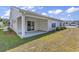 Exterior view of home with covered patio and view of the green lawn at 205 Kinross Ct., Little River, SC 29566