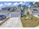 Exterior view of home with driveway and well-kept lawn and landscaping at 205 Kinross Ct., Little River, SC 29566