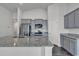 Spacious kitchen featuring granite countertops, gray cabinets, stainless steel appliances, and wood floors at 205 Kinross Ct., Little River, SC 29566
