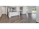 Open-concept kitchen featuring stainless steel appliances, a large island, and views into the living space at 205 Kinross Ct., Little River, SC 29566