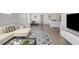 Cozy living room featuring wood floors, a comfortable sofa, a modern rug, and stylish decor at 205 Kinross Ct., Little River, SC 29566