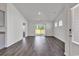 Bright living room features sliding doors, wood floors, and neutral color palette at 205 Kinross Ct., Little River, SC 29566
