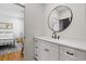 Modern bathroom with a white vanity, elegant round mirror, and contemporary fixtures at 208 Green Lake Dr., Myrtle Beach, SC 29572