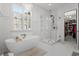 Luxurious bathroom featuring a soaking tub, a glass-enclosed shower, and access to the walk-in closet at 208 Green Lake Dr., Myrtle Beach, SC 29572
