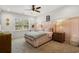 Cozy bedroom features plush carpet, pink accents, and a ceiling fan at 208 Green Lake Dr., Myrtle Beach, SC 29572