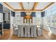 Chic dining room featuring a large table, elegant chandelier, and ample natural light through shuttered windows at 208 Green Lake Dr., Myrtle Beach, SC 29572